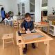Independent Toddler cutting fruit at La Jolla Montessori school