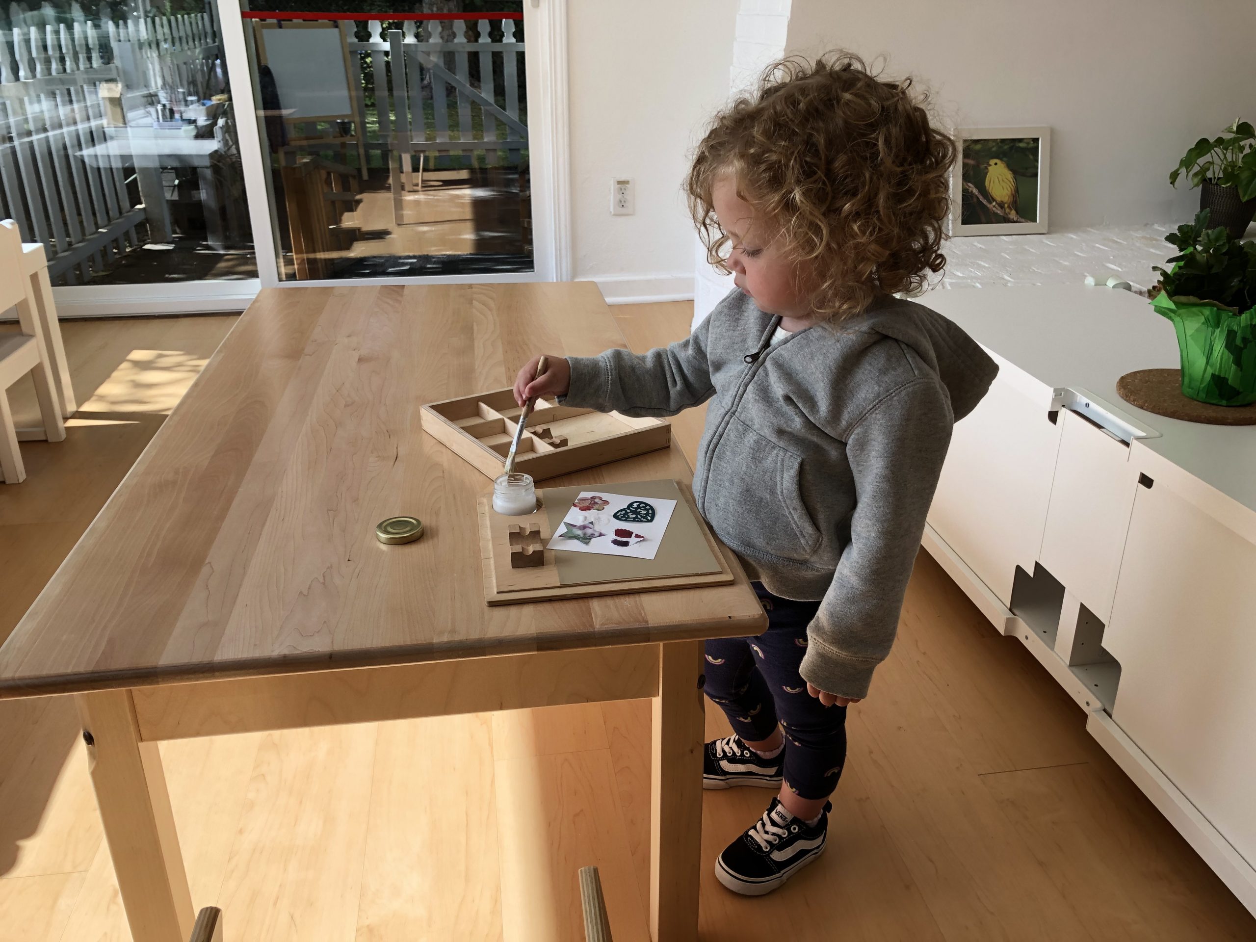 Toddler in a Montessori classroom doing Art