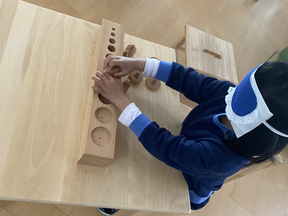 Primary student blindfolded while solving puzzles