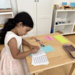 Girl writing in Spanish at a Bilingual Preschool in La Jolla
