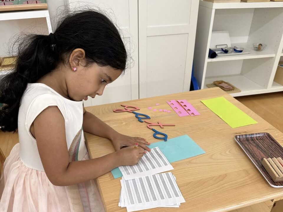 Girl writing in Spanish at a Bilingual Preschool in La Jolla