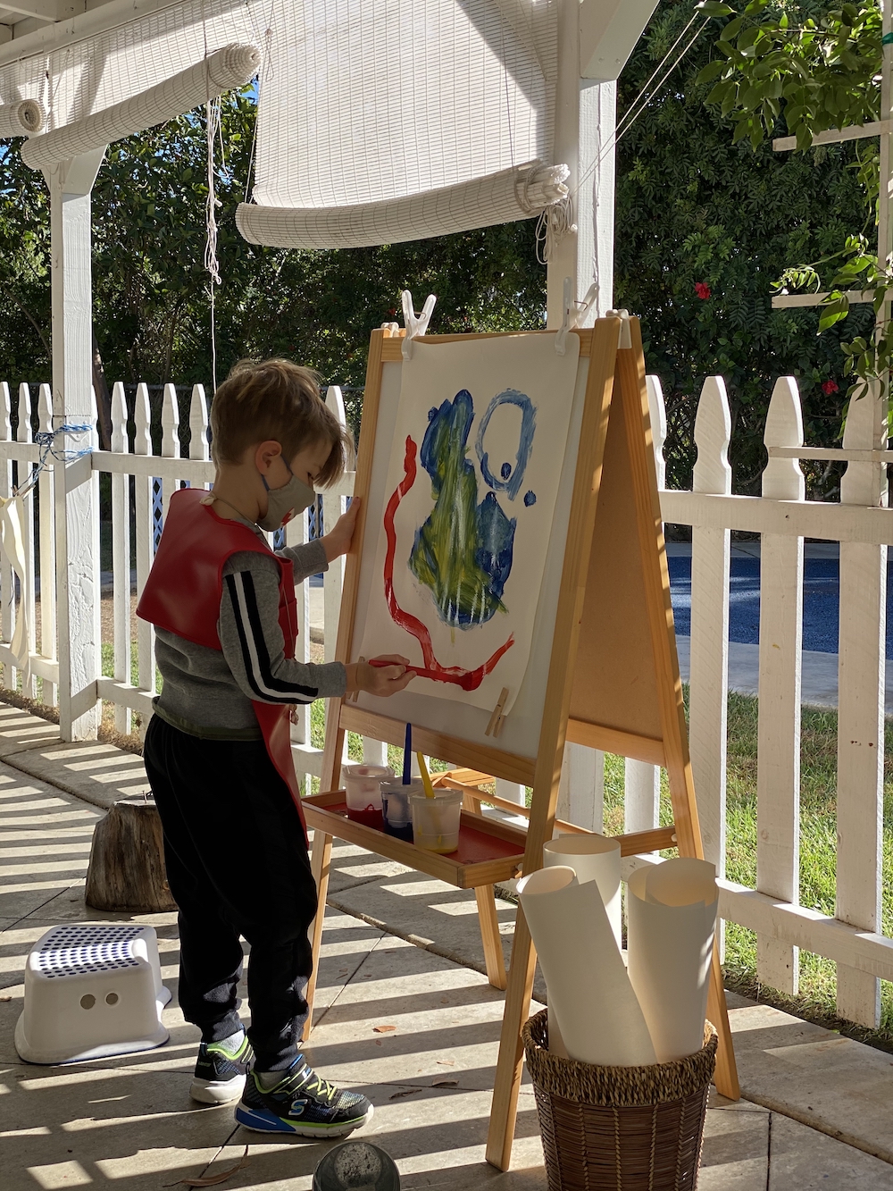 Boy painting outside