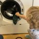 Toddler Doing Loading the Washing Machine at La Jolla Montessori School