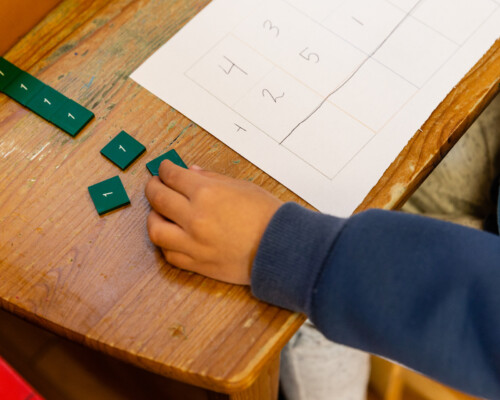 child adding numbers in a Montessori classroom