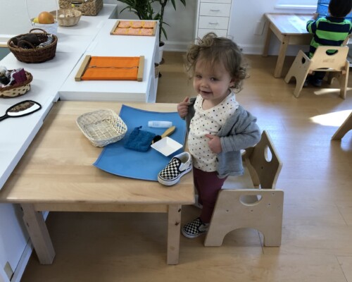Toddler cleaning her shoes independently