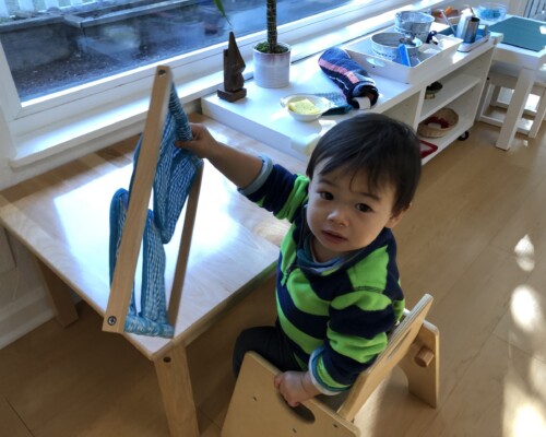 Toddler learning how to button
