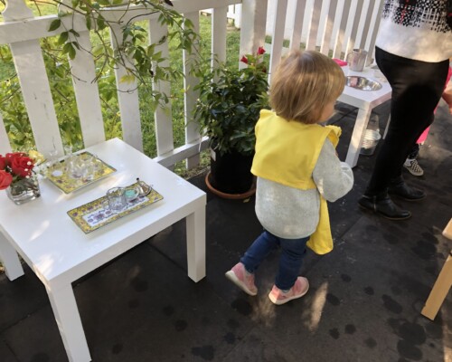 Toddler playing in a Montessori garden