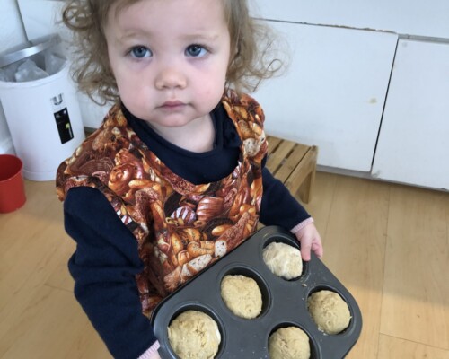 Toddler baking cupcakes