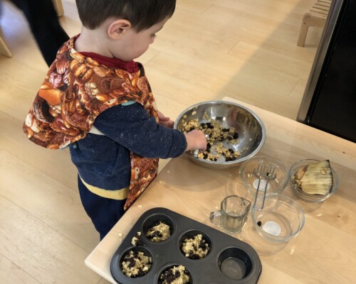 Toddler baking muffins