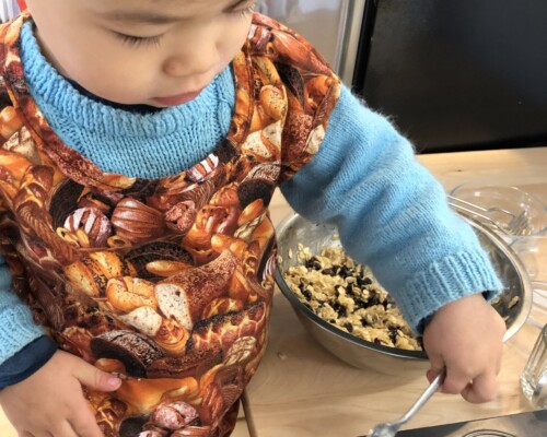Toddler baking muffins