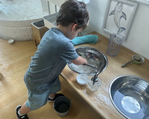 Toddler Care of the Environment Washing Dishes Concentration at La Jolla Montessori