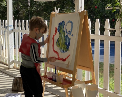 Boy painting outside