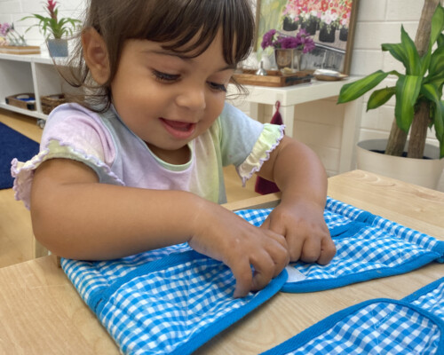Girl learning to velcro Preschool