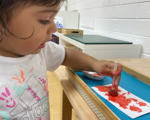 Girl painting independently Preschool
