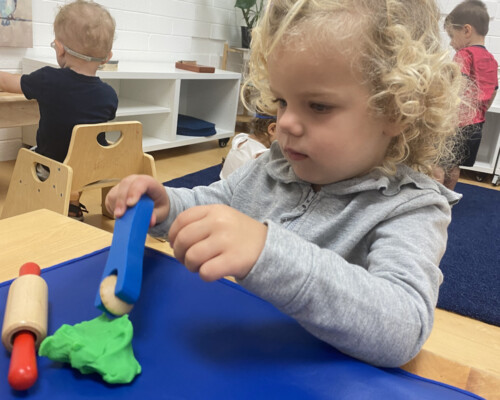 Girl playing with playdoh Preschool