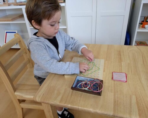 Toddler using fine motor skills independently